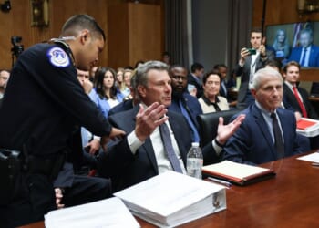 David Schertler, an attorney representing former NIH Director Anthony Fauci, is removed from the hearing room during a hearing before the Senate Homeland Security and Governmental Affairs Committee on July 29, 2026 in Washington.