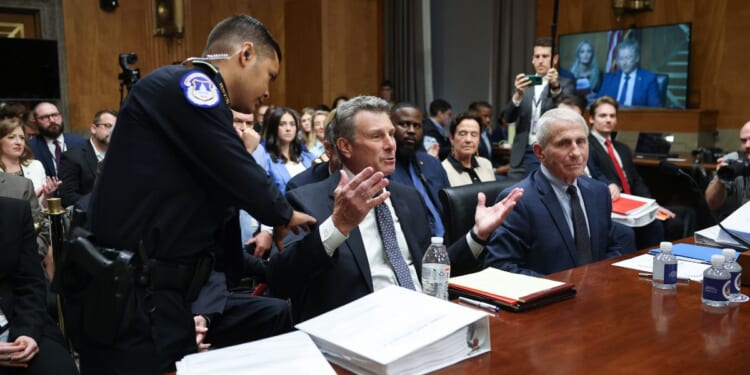 David Schertler, an attorney representing former NIH Director Anthony Fauci, is removed from the hearing room during a hearing before the Senate Homeland Security and Governmental Affairs Committee on July 29, 2026 in Washington.