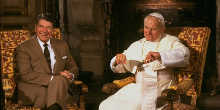 President Ronald Reagan sitting with Pope John Paul II