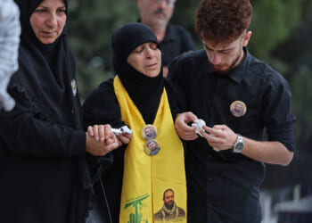 Mourners comfort the mother of Hezbollah fighter Hassan Ali Kallas.