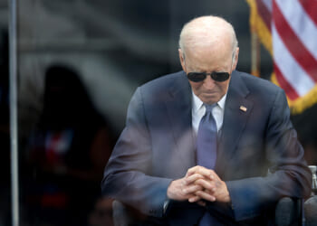 President Joe Biden sits with his head lowered at the Obama Center dedication on June 18, 2026.