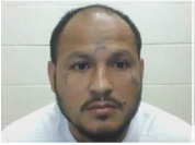 EXCLUSIVE: ICE Arrests 5 Illegal Aliens Convicted of 'Repulsive' Crimes 1 A man with a beard and receding hairline, wearing a white shirt, looks at the camera. The background is a white tiled wall.