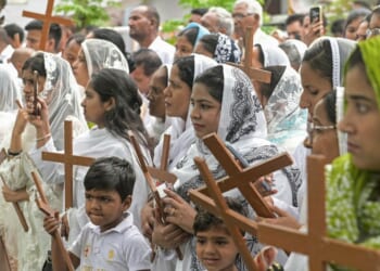 Christians hold up crosses in Amritsar, India, during a Good Friday procession on April 3, 2026.