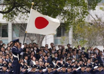 New students of the National Defense Academy salute the Japanese national flag at a review parade as part of the their entrance ceremony in Yokosuka, Kanagawa Prefecture, on April 5, 2026.