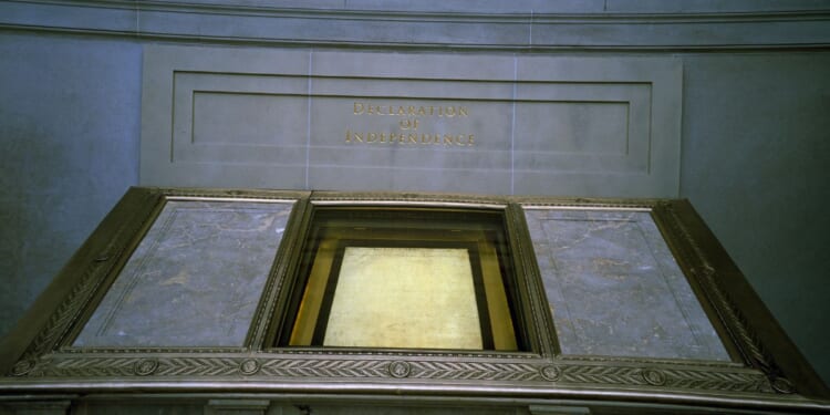 The Declaration of Independence, displayed in a dimly lit hall at the National Archives, reserved for the original Charters of Freedom in Washington, D.C.