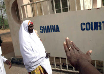Safiya Husseini, in company of her brother Sanni, arrives at the Sokoto State Sharia Court of Appeal, 18 March, 2002 to appeal against the judgement of an Islamic court which sentenced her to death by stoning.