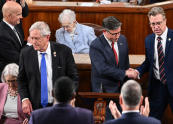 Representative Keith Self, Republican from Texas, and Representative Ralph Norman, Republican from South Carolina, look on as US Speaker of the House Mike Johnson, Republican from Louisiana, shakes hands with Representative Andy Ogles.