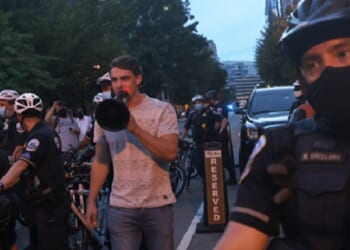 Jacob Wohl, now a convicted felon, is pictured taunting leftist protesters during a "Trump/Pence Out Now" rally in August 2020.
