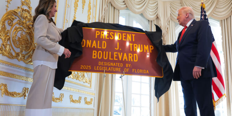 Florida State Rep. Meg Weinberger and U.S. President Donald Trump unveil a "President Donald J. Trump Boulevard" sign during a Road Dedication Ceremony at Mar-a-Lago.