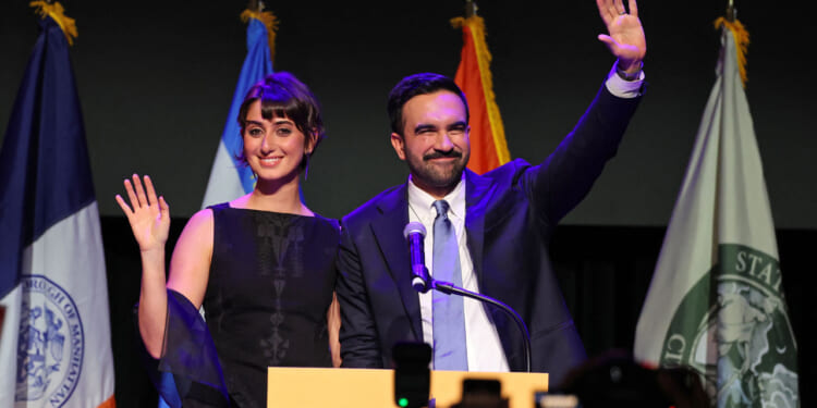 Zohran Mamdani and wife Rama Duwaji wave to crowd election night.