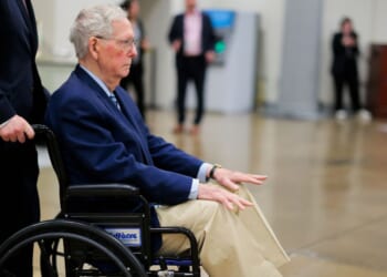 Sen. Mitch McConnel is pushed in a wheelchair through the Senate Subway during the Senate War Powers vote on April 22, 2026, in Washington, D.C.