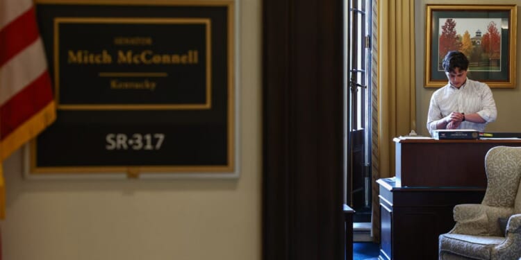 A staff member checks his watch inside of Mitch McConnell's office July 8 in Washington, D.C. McConnell's health has become the subject of speculation.