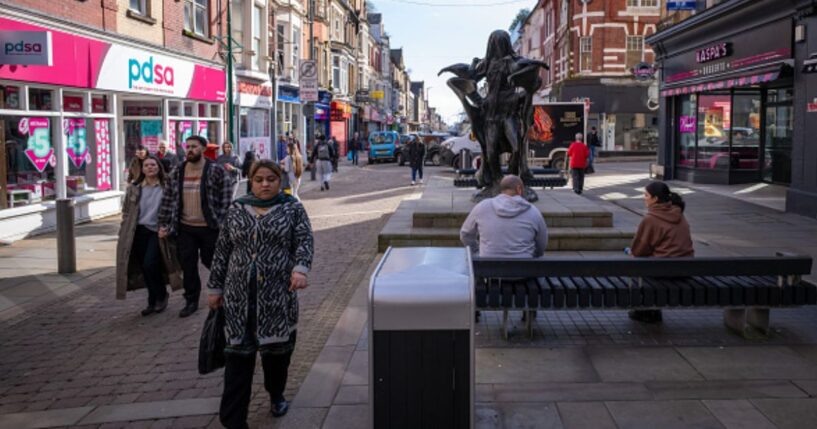 People walk along the square in Newport, Wales on March 2, 2026.