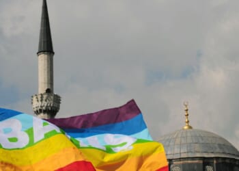 Turkish activists wave flags in front of a mosque in Istanbul on March 16, 2010, during a demonstration against Family Affairs Minister Aliye Selma Kavaf.