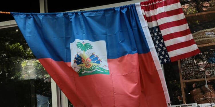 An American and Haitian flag hang on a bar outside a shop on June 25, 2026.