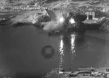 In this handout footage provided by the U.S Department of War, U.S. sea drones strike a submarine and a ship maintenance facility on July 13, 2026, in an undisclosed area of Iran.