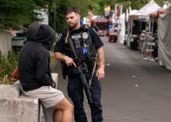 A police officer talks to people while responding to a shooting at the Bite of Seattle food festival on July 26, 2026 in Seattle, Washington.