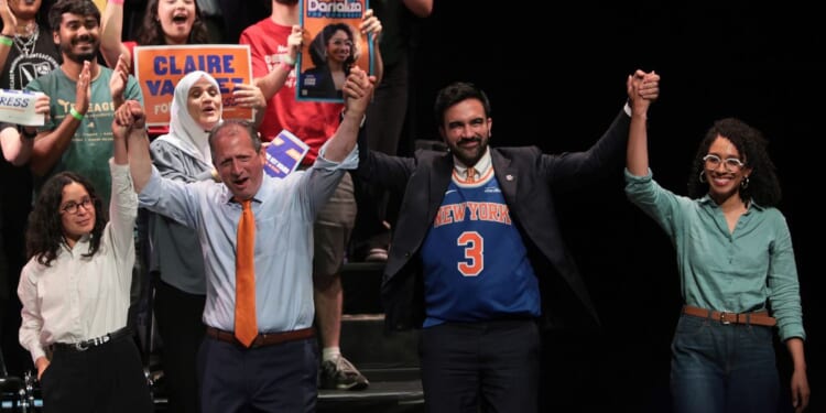Congressional candidate Claire Valdez, Congressional candidate Brad Lander, Mayor Zohran Mamdani, and Congressional candidate Darializa Avila Chevalier raise their hands during a Get Out the Vote rally at King's Theater on June 18, 2026, in New York City.