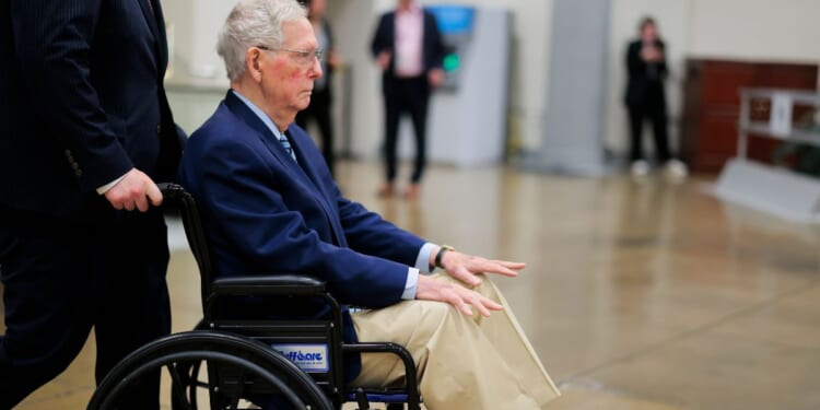 Sen. Mitch McConnel is pushed in a wheelchair through the Senate Subway during the Senate War Powers vote on April 22, 2026, in Washington, D.C.
