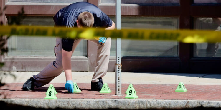 Police investigate on Cambridge Street outside offices of Massachusetts General Hospital on May 27, 2025 after a police-involved shooting. (Photo by Lane Turner/The Boston Globe via Getty Images)