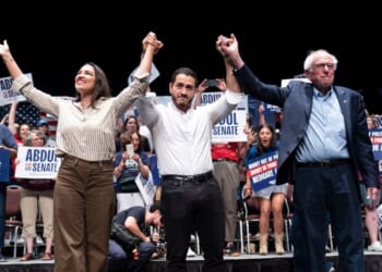 Rep. Alexandria Ocasio-Cortez, Michigan Democratic candidate for Senate Abdul El-Sayed, and Sen. Bernie Sanders greet the crowd after El-Sayed spoke at The People v. The Powerful rally at the Detroit Opera House on July 18 in Detroit, Michigan.