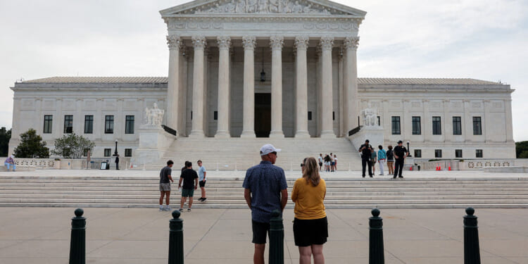 People stand outside the U.S. Supreme Court in Washington, D.C., U.S., June 22, 2026. REUTERS/Kylie Cooper/File Photo