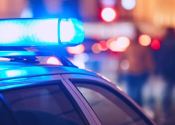 Flashing blue lights above a law-enforcement vehicle.