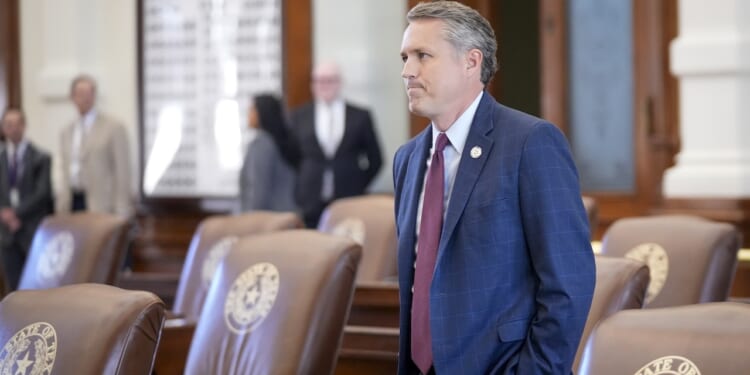 Texas state Rep. Brian Harrison arrives in the House Chamber at the Capitol in Austin.