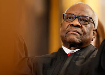 Close-up of Clarence Thomas in judicial robes leaning back.