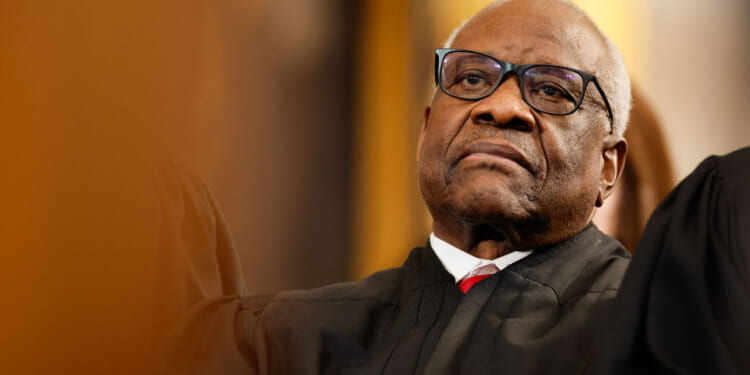 Close-up of Clarence Thomas in judicial robes leaning back.