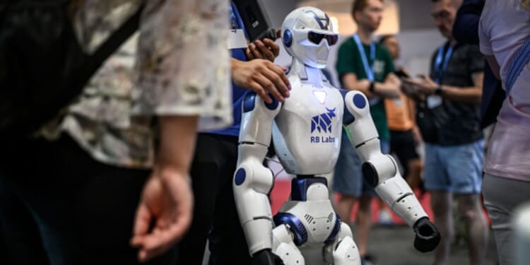 A robot stands amongst a crowd at the AI for Good Global Summit on July 7, 2026.