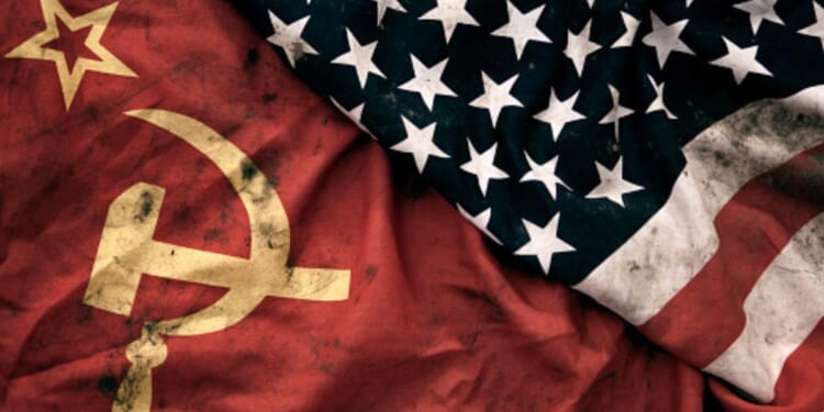 Muddied USSR and American flags lay next to each other.