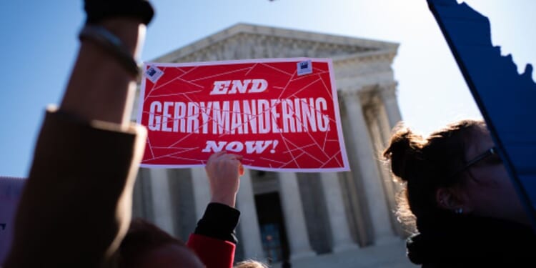 Gerrymandering protesters demonstrate outside the Supreme Court building on March 19, 2019.