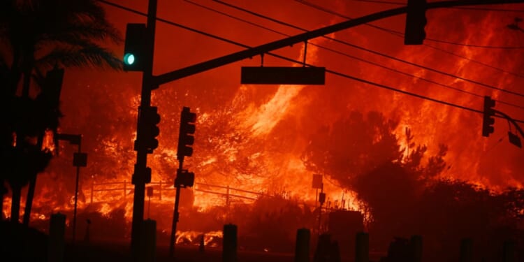 Flames engulf the intersection of Temescal Canyon and the Pacific Coast Highway as the Palisades Fire devastates a Los Angeles suburb on Jan. 7, 2025.