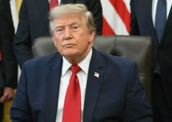 President Donald Trump looks on after signing an executive order to drastically shrink two national monuments in Utah, paving the way for fossil fuel extraction and mining, at the Oval Office of the White House in Washington, D.C., on July 13, 2026.