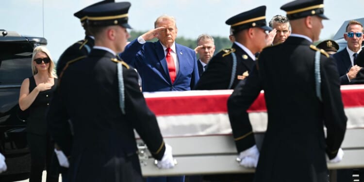 President Donald Trump salutes Wednesday as a U.S. Army team carries the flag-draped transfer case containing the remains of 1st Lt. Tyler James Feehan, 25, of Ewa Beach, Hawaii, during a dignified transfer event at Dover Air Force Base in Dover, Delaware, for U.S. service members killed during operations in the Middle East. Feehan was killed in action Saturday during an enemy attack at Muwaffaq Salti Air Base in Jordan.