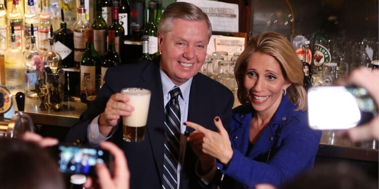GOP Sen. Lindsey Graham of South Carolina and his sister, Darline Graham Nordone, serve guests prior to CNN's "Politics On Tap" at Walnut Brewery on Oct. 27, 2015, in Boulder, Colorado.