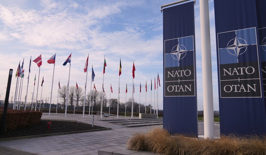Flags flap in the wind outside NATO headquarters in Brussels, Jan. 19, 2026. (AP Photo/Virginia Mayo, File)