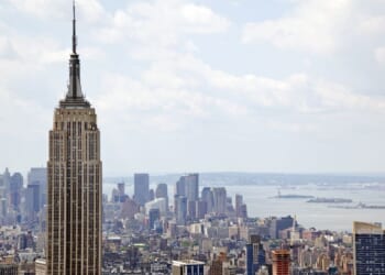 The couple climbed to the very top of the famed New York City landmark - with no safety equipment.