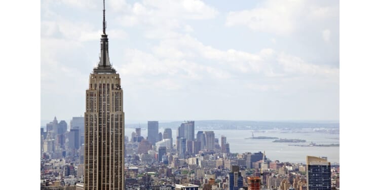 The couple climbed to the very top of the famed New York City landmark - with no safety equipment.