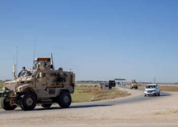 A U.S. military mine-resistant ambush protected armored fighting vehicle drives along a highway outside Qamishli in Syria's northeastern Hasakah province on Feb. 22, 2026.