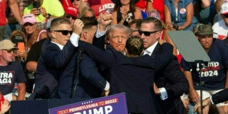 President Donald Trump is seen with blood on his face surrounded by Secret Service agents as he is taken off the stage at a campaign event at Butler Farm Show Inc. in Butler, Pennsylvania, on July 13, 2024.