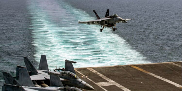 A Navy F/A 18E Super Hornet lands on the USS Abraham Lincoln in a file photo from the outbreak of Operation Epic Fury, the U.S. attack on Iran in February.
