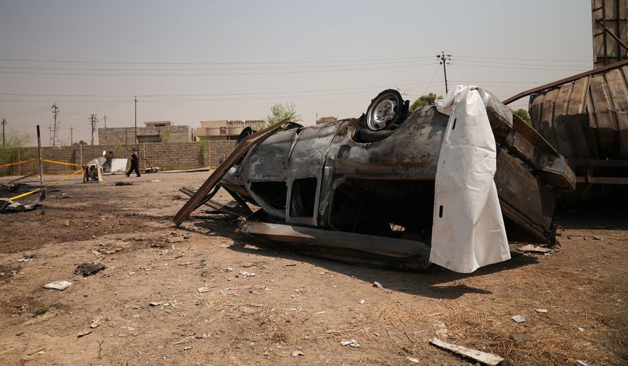 A damaged vehicle at the site of an airstrike on a Popular Mobilization Forces base in Mosul, Iraq, Wednesday, July 29, 2026. (AP Photo/Farid Abdulwahed)