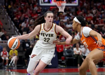 Caitlin Clark of the Indiana Fever dribbles the ball while defended by Nell Angloma of the Connecticut Sun at Gainbridge Fieldhouse on July 22, 2026, in Indianapolis, Indiana.