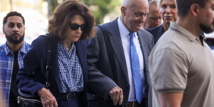 The parents of Charlie Kirk walk to the courthouse.