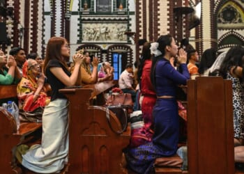 Christians pray at a church on Christmas Eve in Yangon on Dec. 24, 2025.