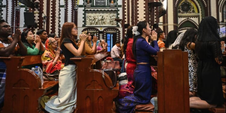 Christians pray at a church on Christmas Eve in Yangon on Dec. 24, 2025.