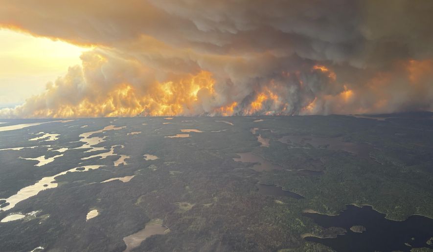 This photo provided by the Manitoba government shows wildfires in Flin Flon, Manitoba, Canada, on Tuesday, May 27, 2025. (Manitoba government via AP) ** FILE **