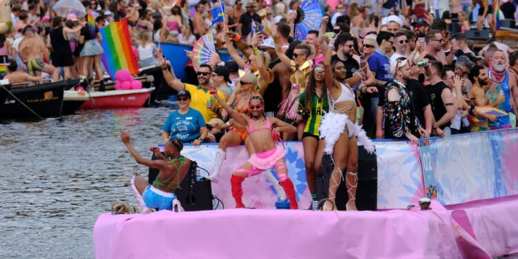 Hundreds of thousands line Amsterdam canals for the annual Pride boat parade